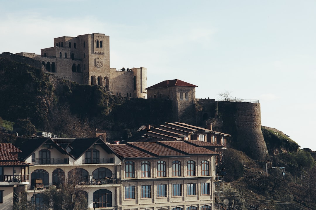 a castle on top of a hill next to a building