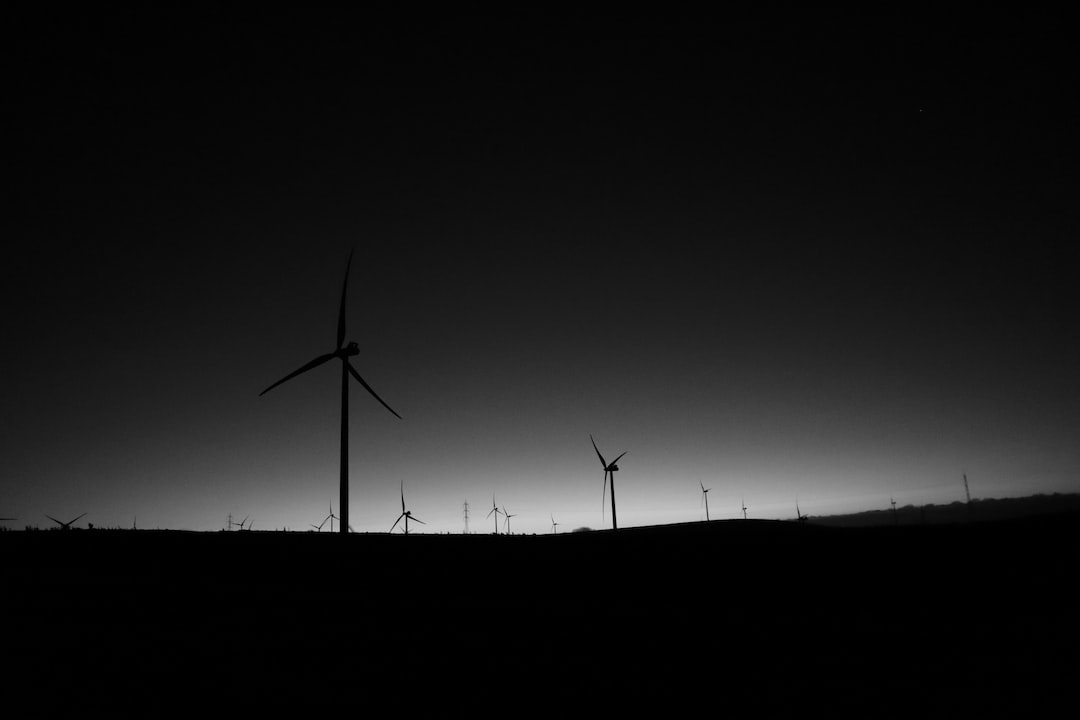 a black and white photo of a wind farm